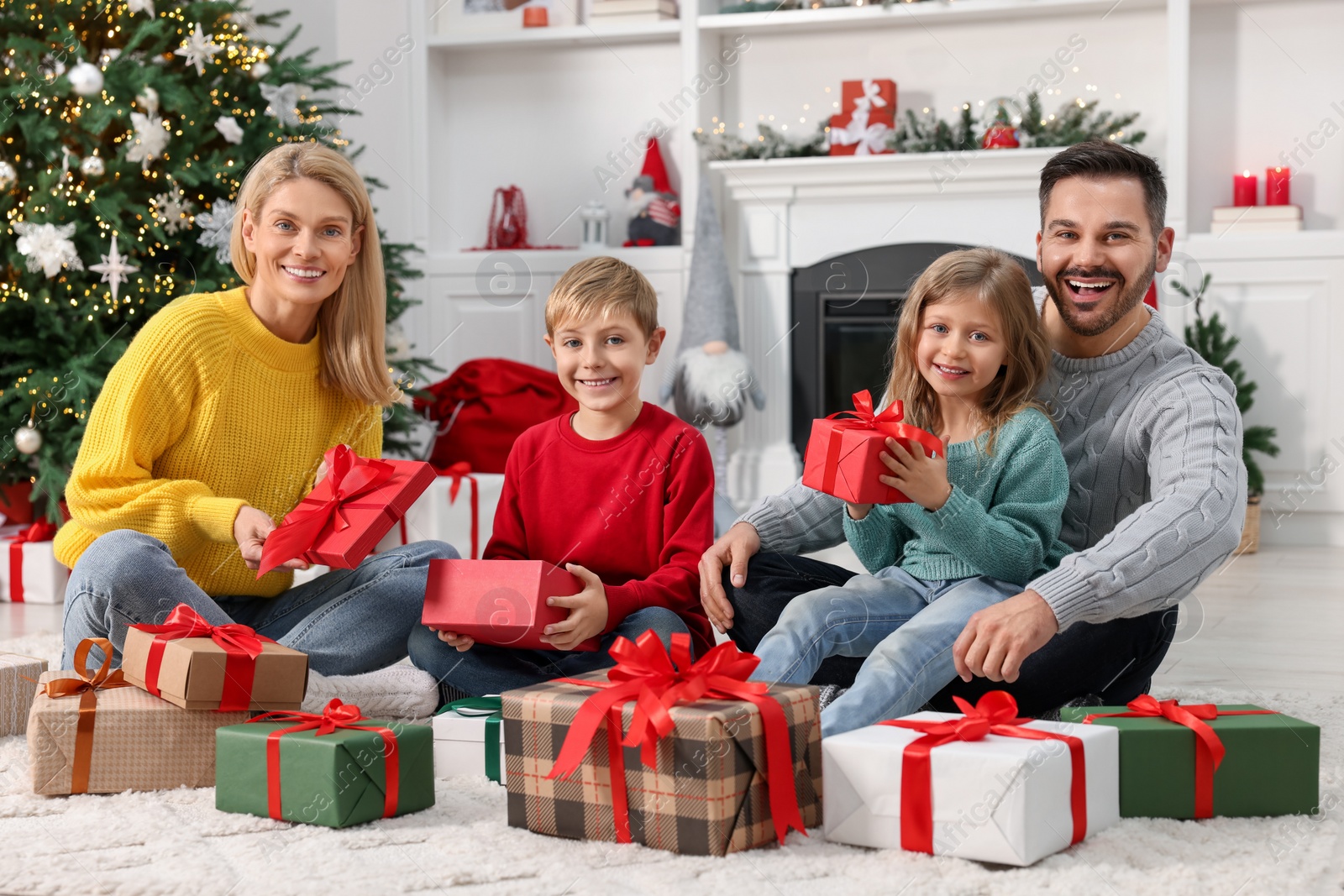 Photo of Happy family with Christmas gifts at home