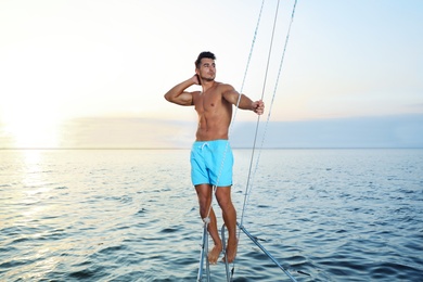 Photo of Young wealthy man on yacht enjoying sunset