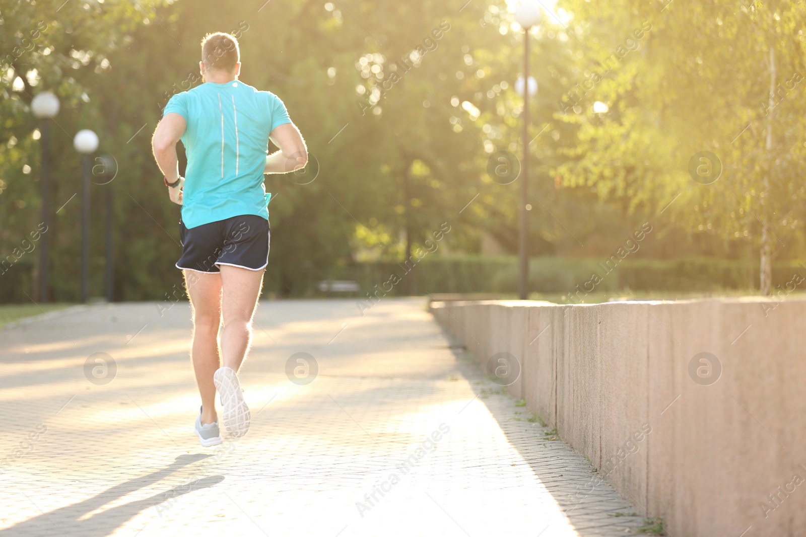 Photo of Young man running in park on sunny day