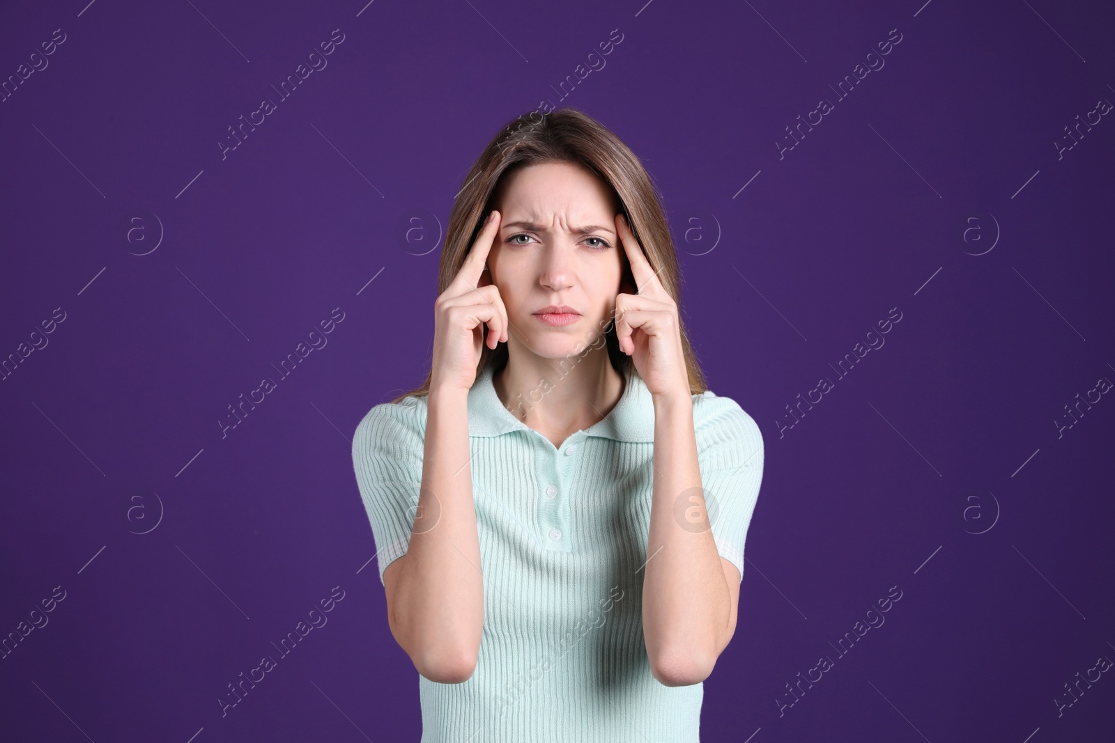 Photo of Portrait of stressed young woman on purple background