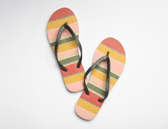 Photo of Pair of flip flops on white background, top view. Beach accessories