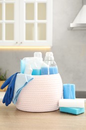 Different cleaning supplies in basket on table