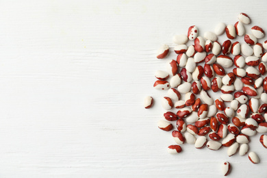 Photo of Raw beans and space for text on white wooden background, flat lay. Vegetable seeds