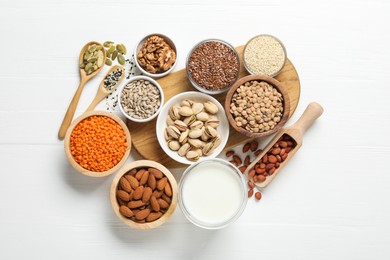 Photo of Different products high in natural fats on white wooden table, flat lay