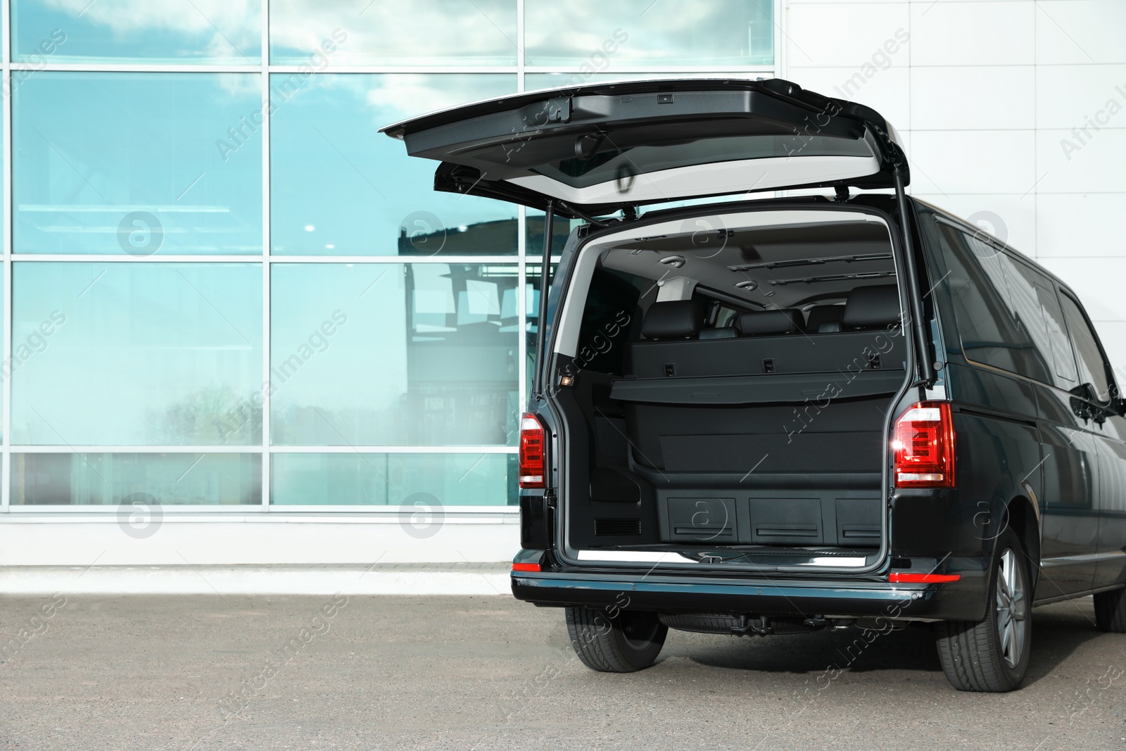 Photo of Modern car with open empty trunk outdoors