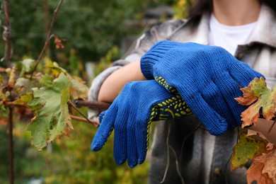 Photo of Woman wearing gloves having rest in garden, closeup