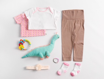 Set of baby clothes and accessories on light background, flat lay