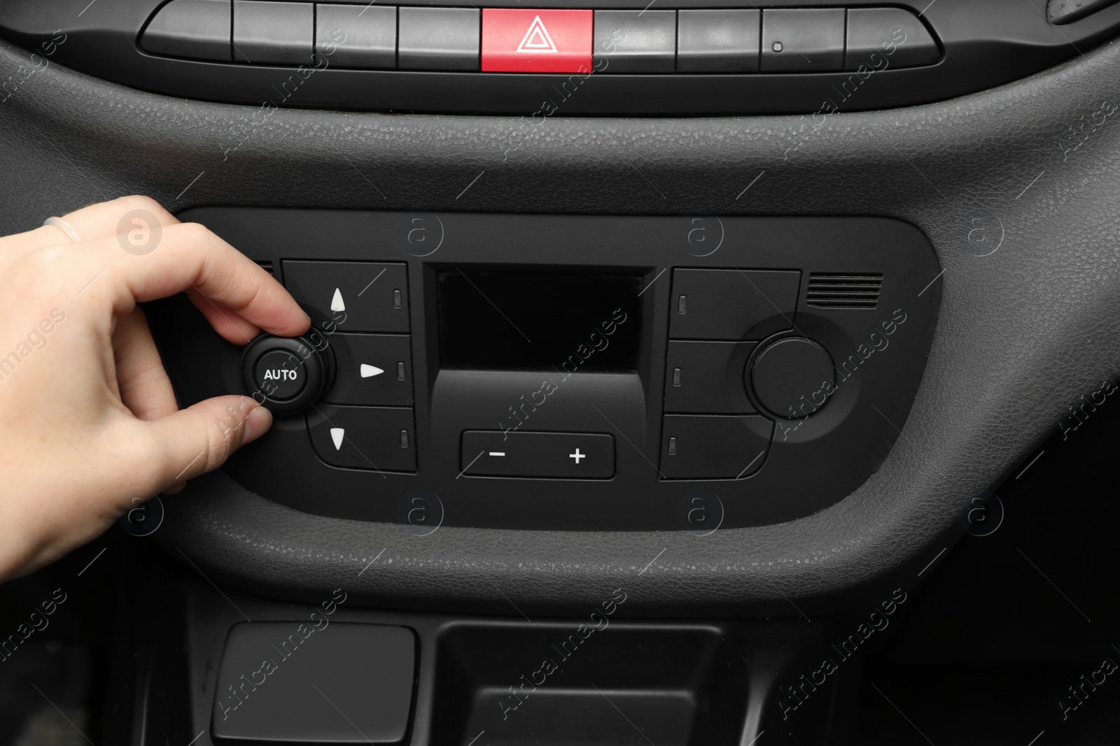 Photo of Woman adjusting air conditioner in car, closeup