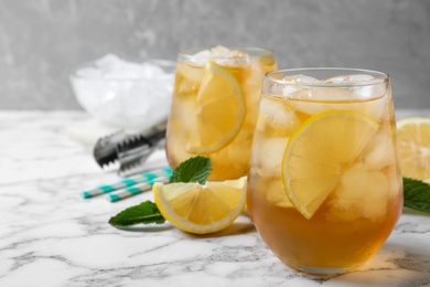 Photo of Delicious iced tea on white marble table