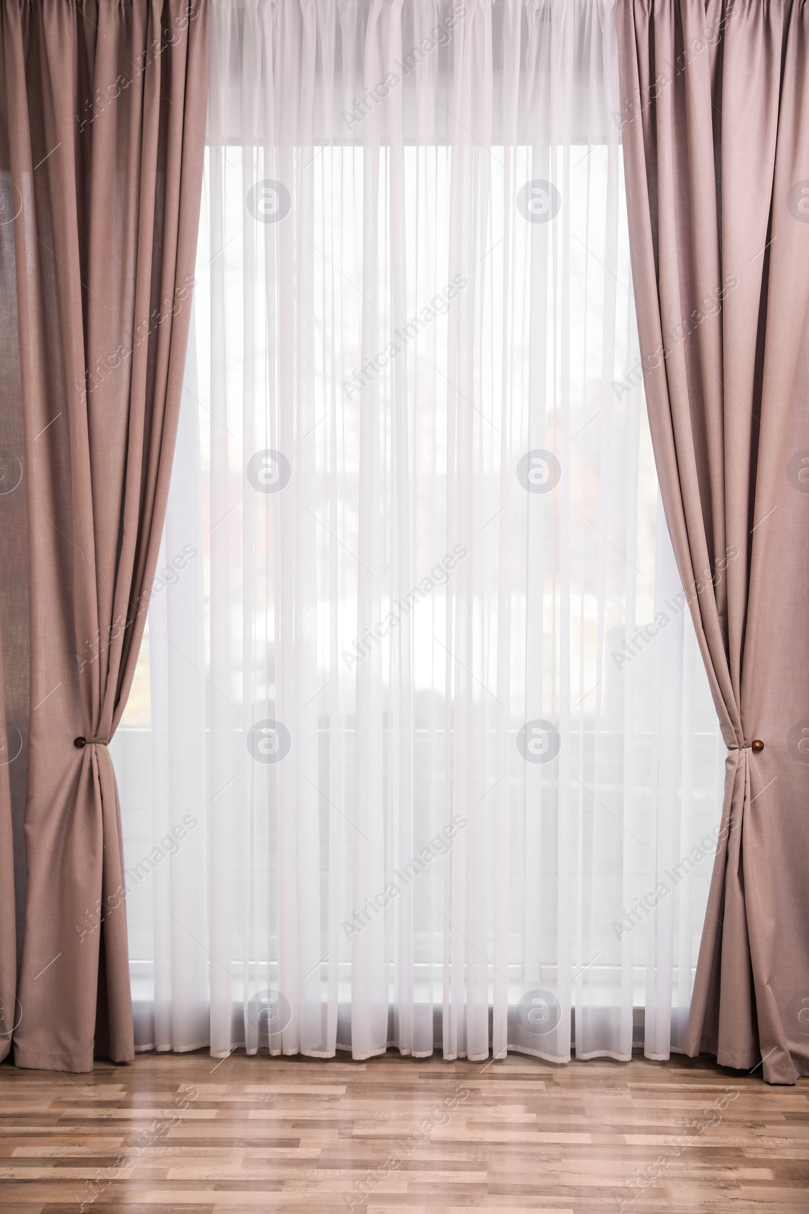 Photo of Window with elegant curtains in empty room