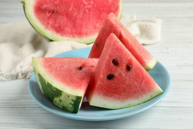 Photo of Delicious fresh watermelon slices on white wooden table, closeup