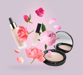 Image of Spring flowers and makeup products in air on dusty pink background