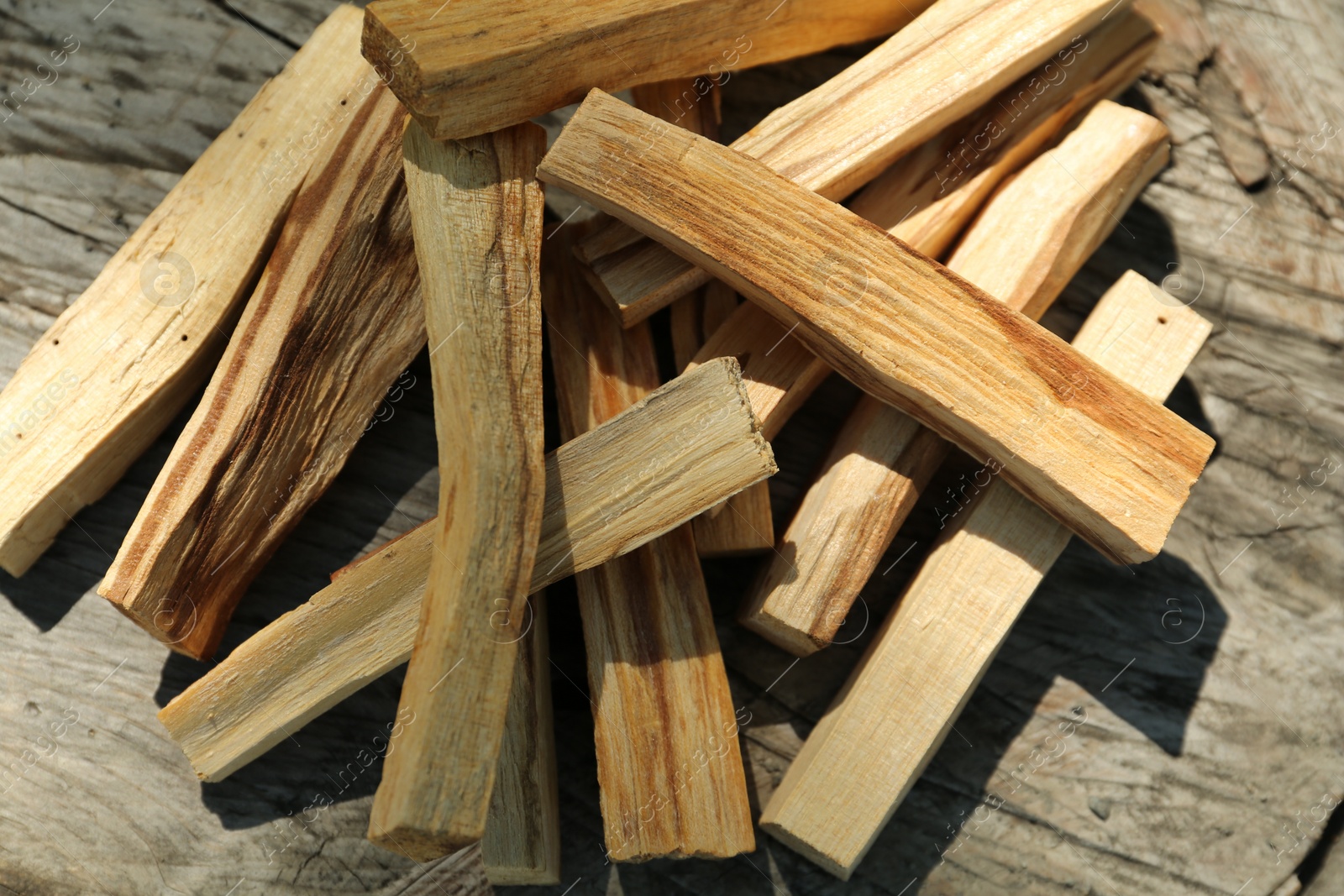 Photo of Palo santo sticks on wooden table, top view