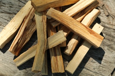 Palo santo sticks on wooden table, top view