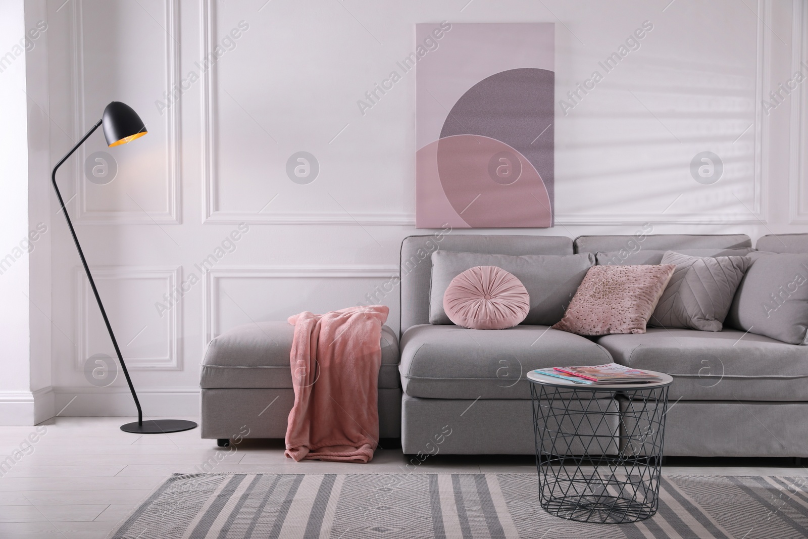 Photo of Cozy living room interior with comfortable grey sofa and beautiful picture