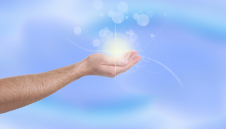 Image of Man holding concentrated healing energy in his hand, closeup