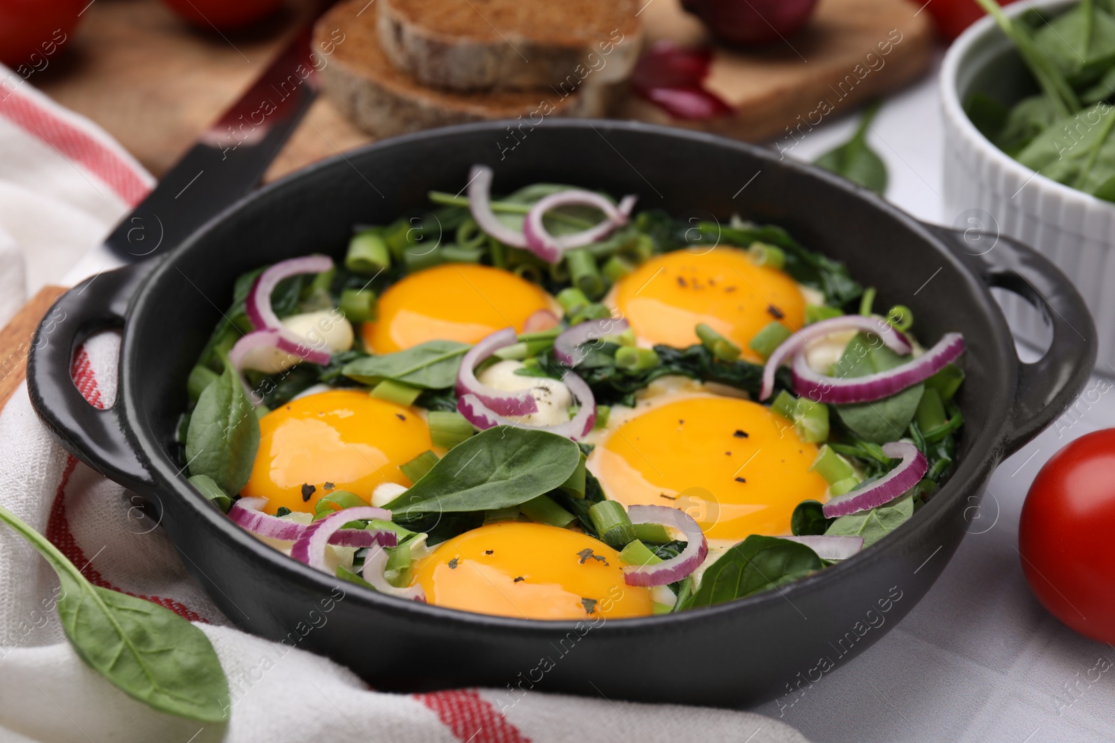 Photo of Tasty Shakshouka served on white table, closeup