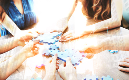 Double exposure of people with puzzle and cityscape