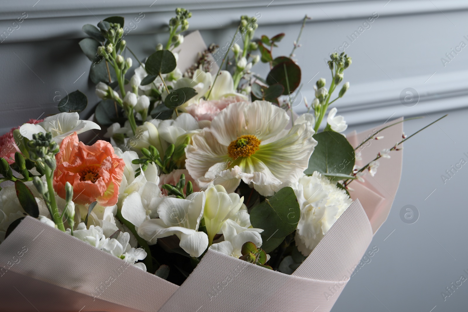 Photo of Bouquet of beautiful flowers on grey background, closeup