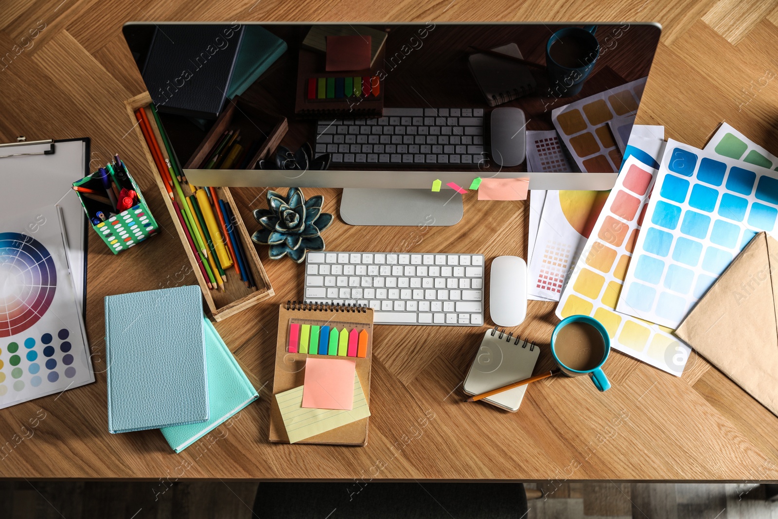 Photo of Designer's workplace with modern computer and color palettes, flat lay