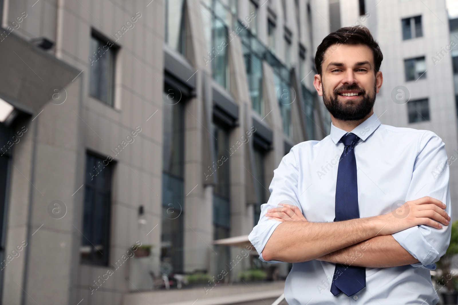 Photo of Handsome businessman in stylish outfit on city street