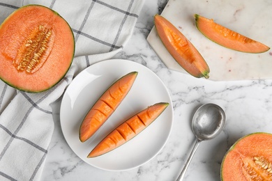 Photo of Flat lay composition with ripe cantaloupe melon on white marble table