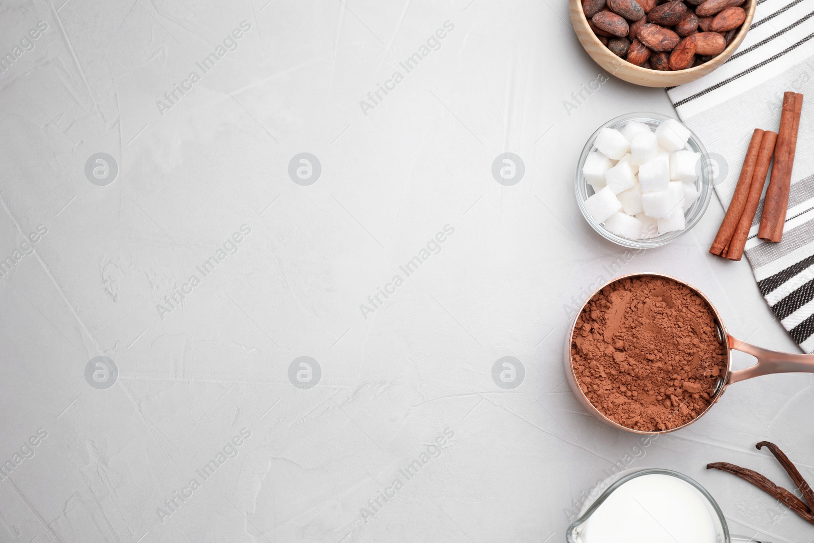 Photo of Flat lay composition with cocoa powder on light table, space for text