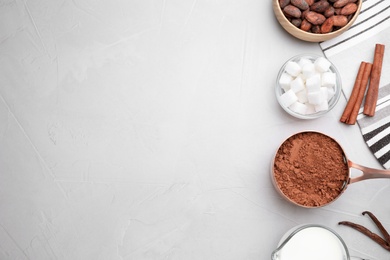 Flat lay composition with cocoa powder on light table, space for text