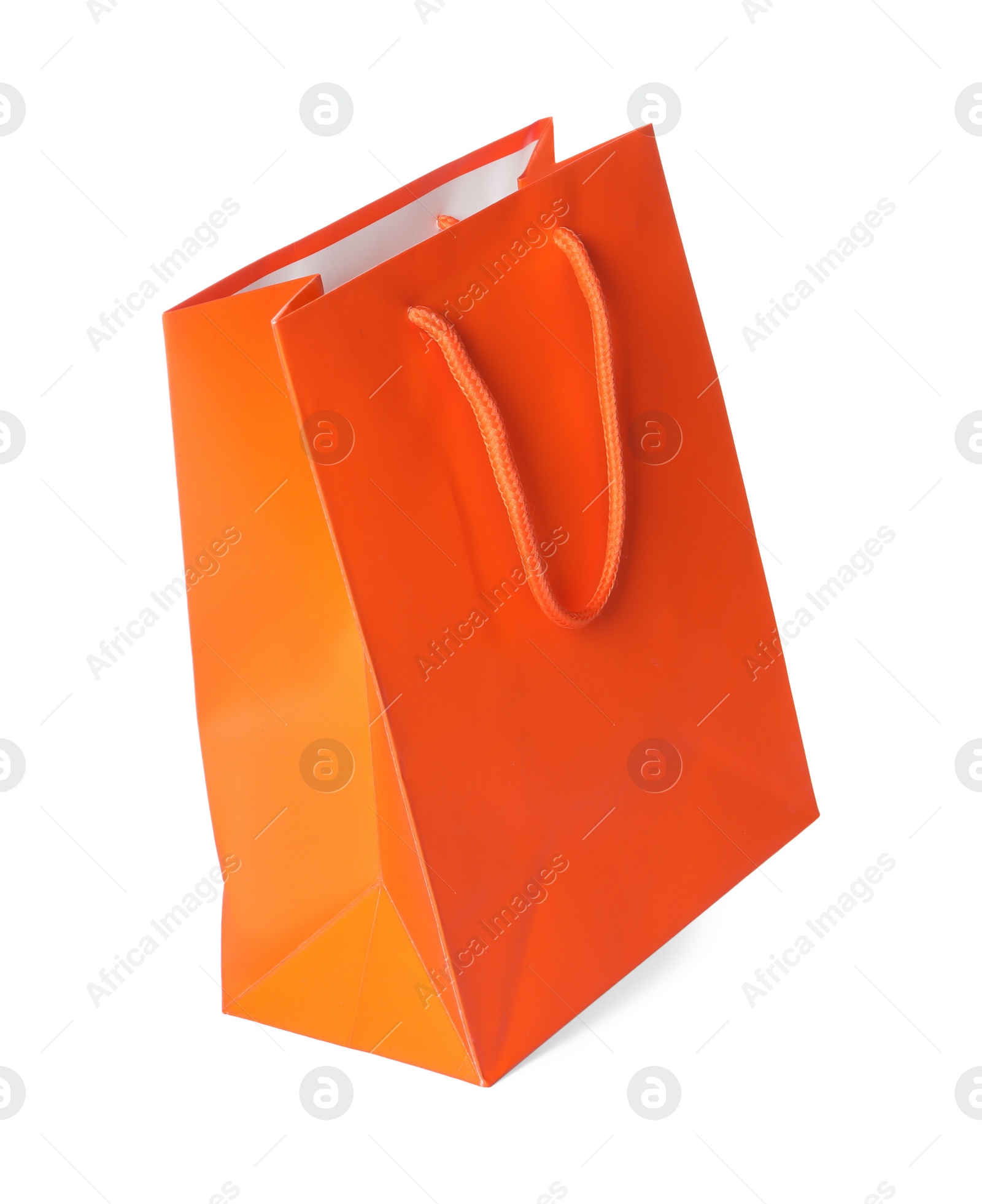 Photo of One orange shopping bag isolated on white