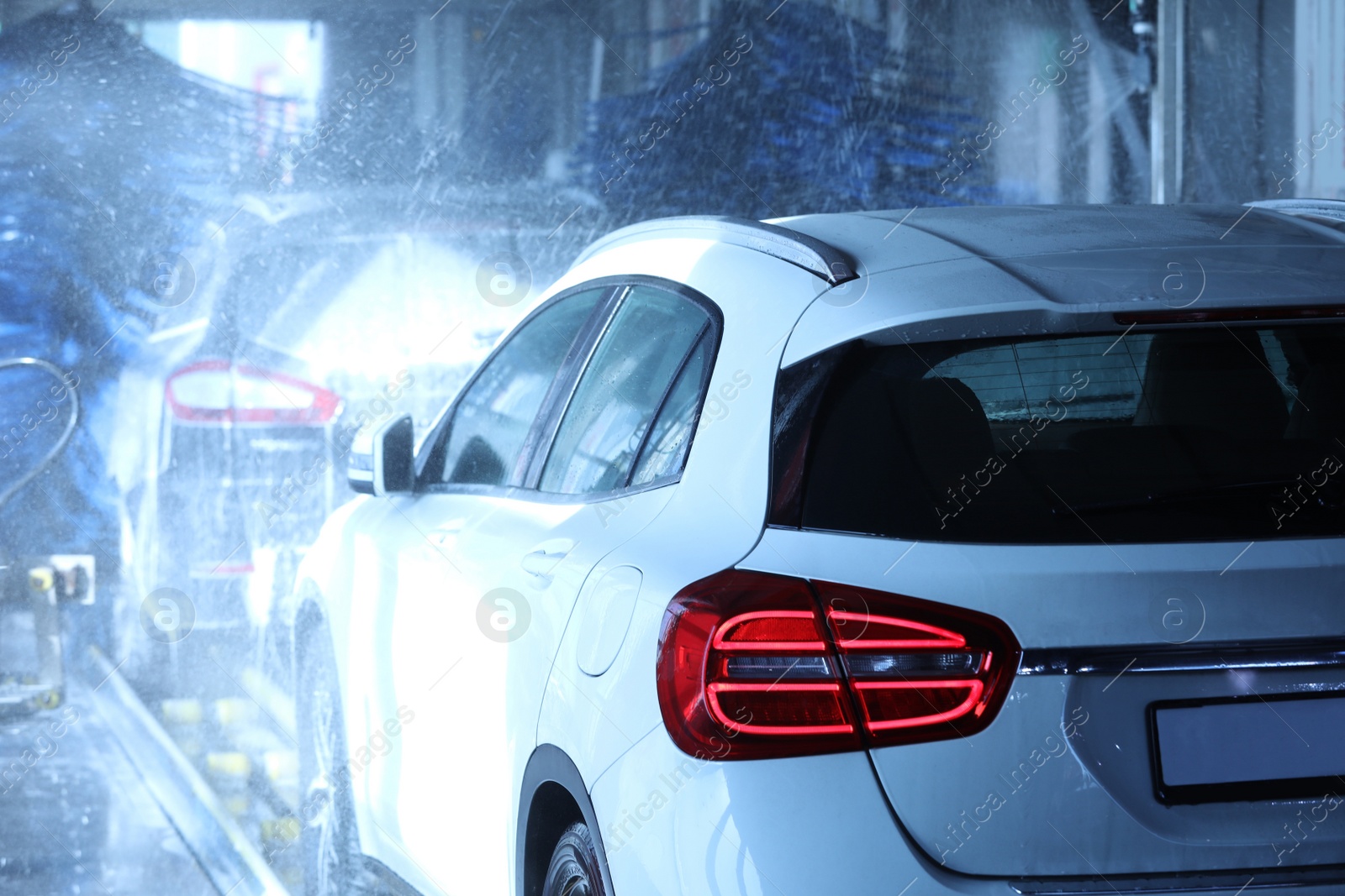 Photo of Modern auto undergoing cleaning at car wash