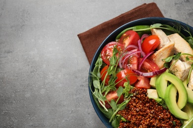 Photo of Delicious avocado salad with quinoa on grey table, top view. Space for text