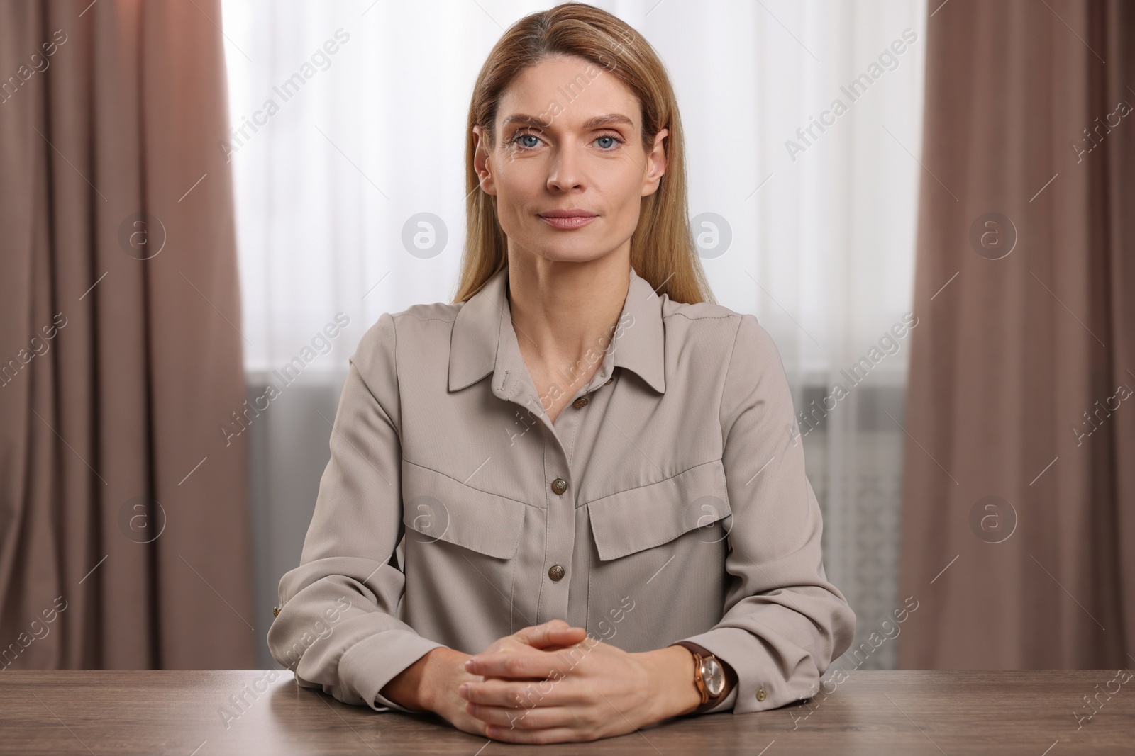 Photo of Woman having video call at wooden table indoors, view from web camera