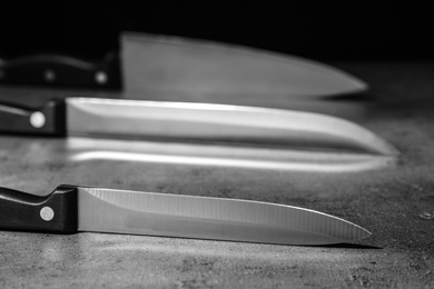 Sharp knives on table against dark background