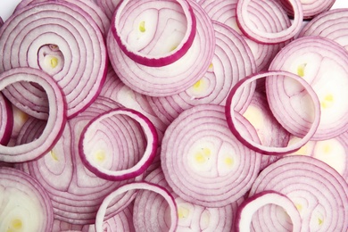 Photo of Sliced fresh red onions as background, top view