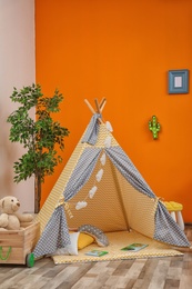 Photo of Cozy kids room interior with play tent and toys