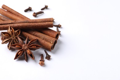 Photo of Different spices on white table, above view. Space for text