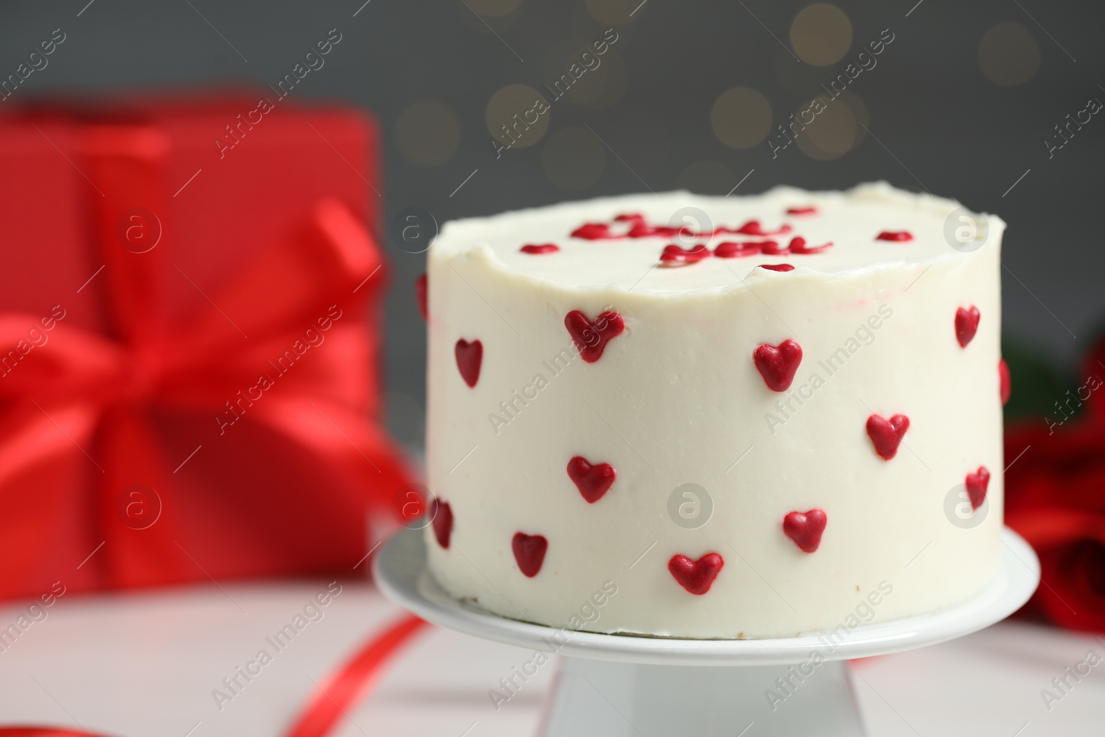 Photo of Bento cake and gift box on white table, closeup. St. Valentine's day surprise