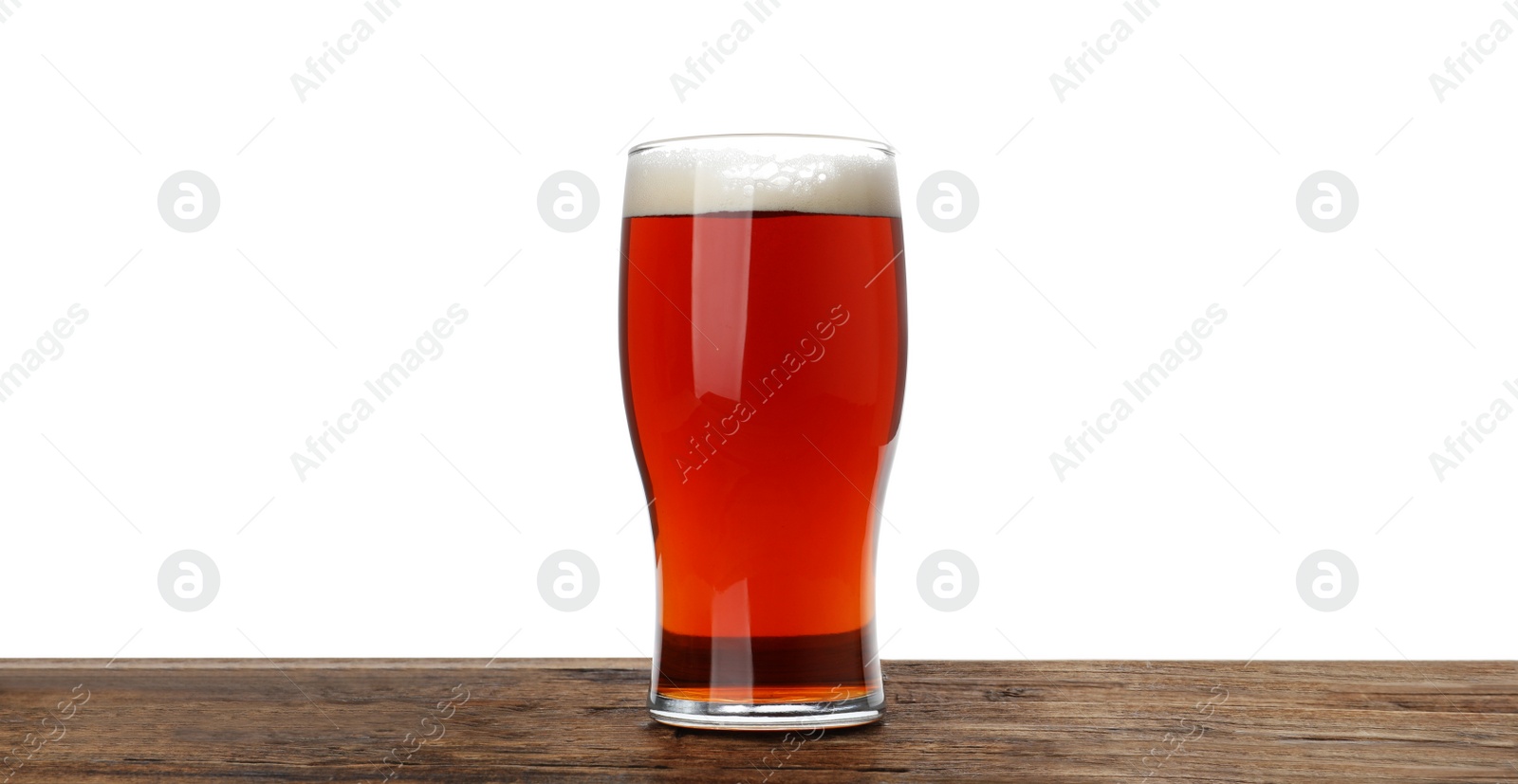 Photo of Glass of delicious kvass on wooden table, white background