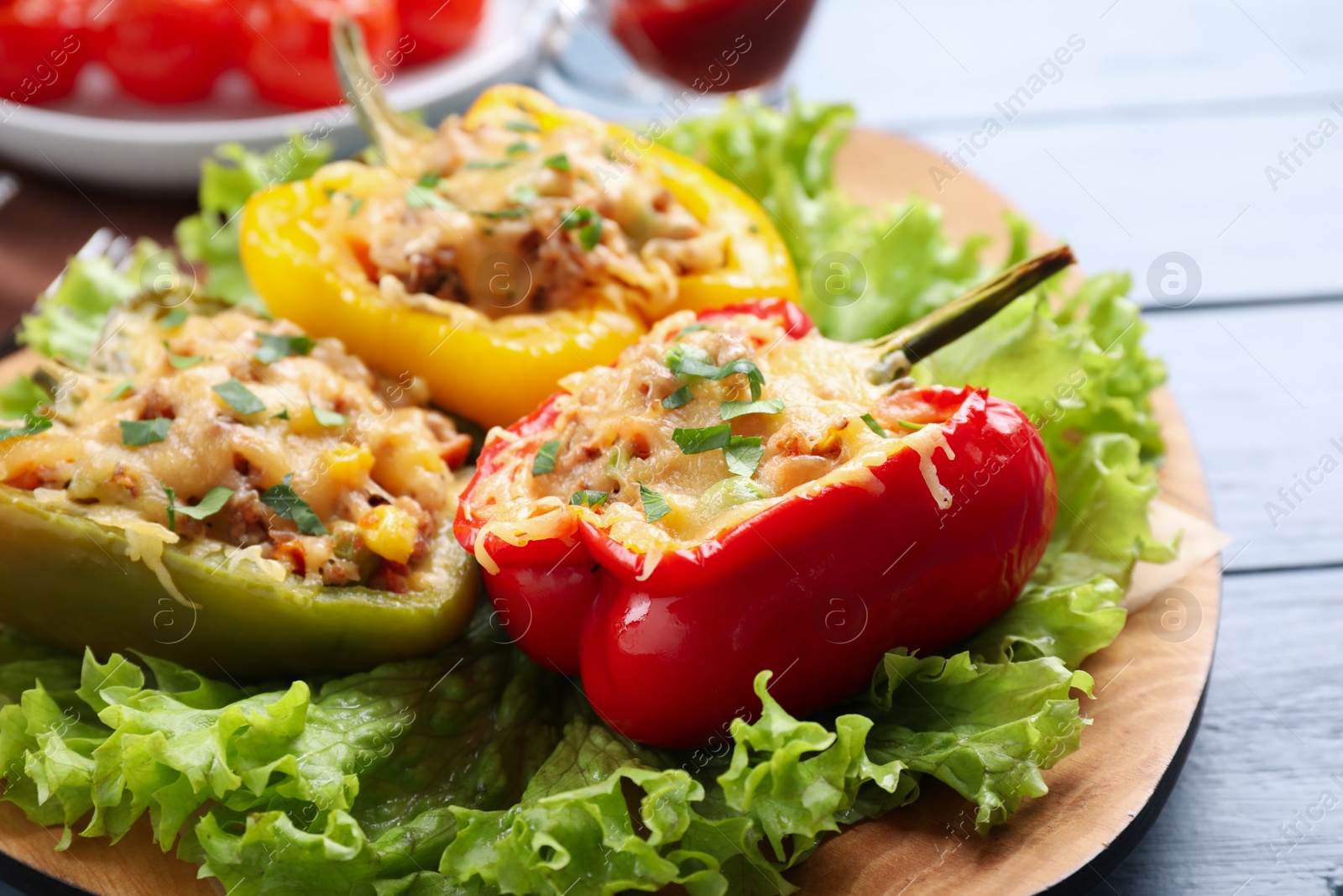 Photo of Tasty stuffed bell peppers on wooden table, closeup