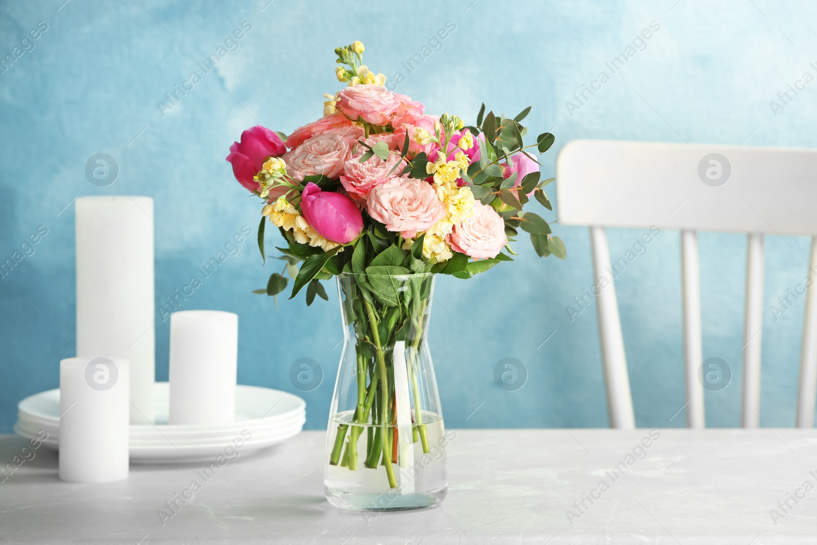 Photo of Vase with bouquet of beautiful flowers on table