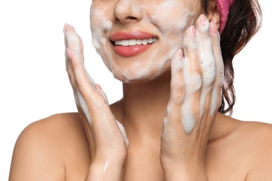 Photo of Beautiful woman applying facial cleansing foam on white background, closeup