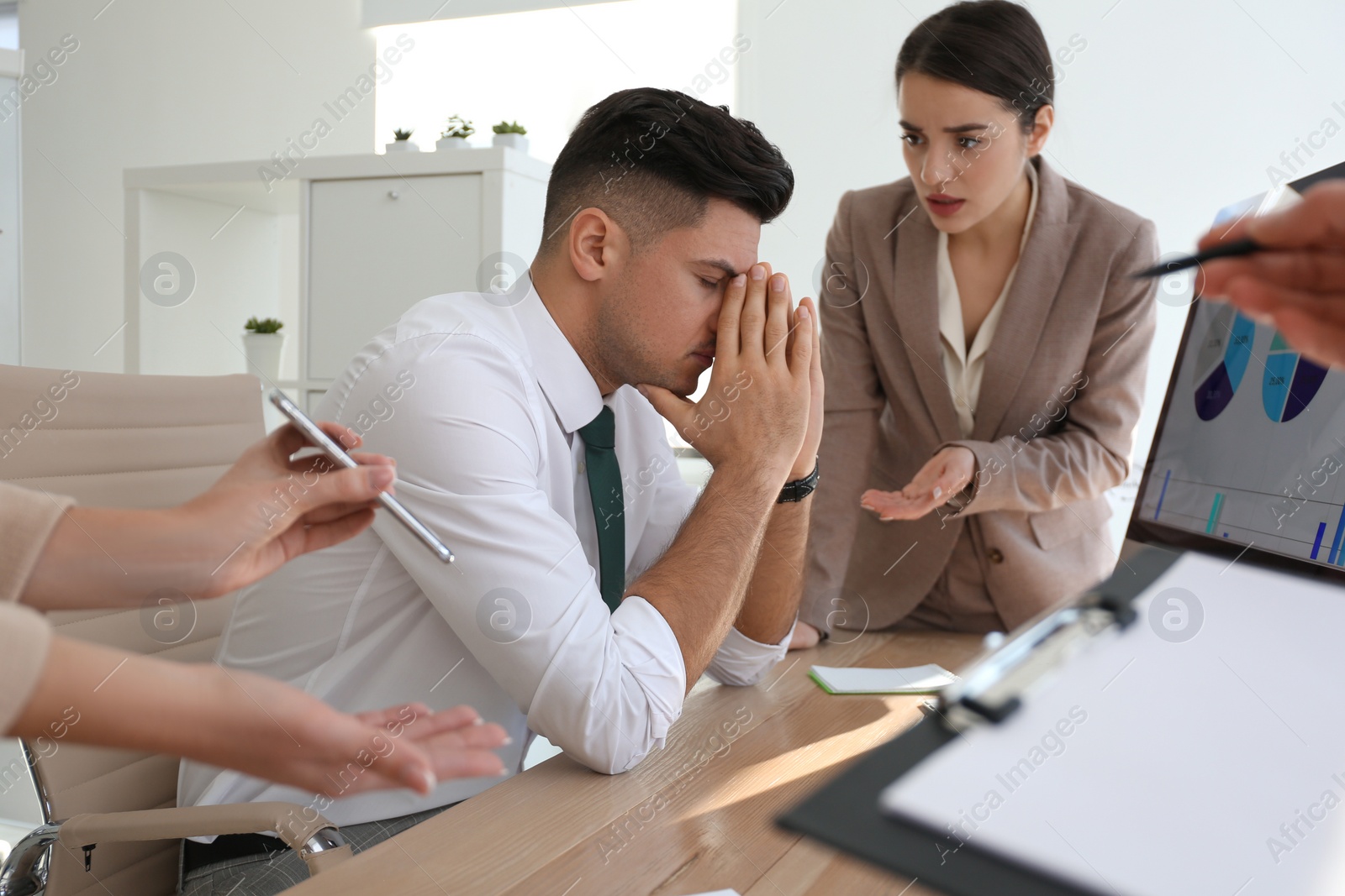 Photo of Businessman stressing out at workplace in office