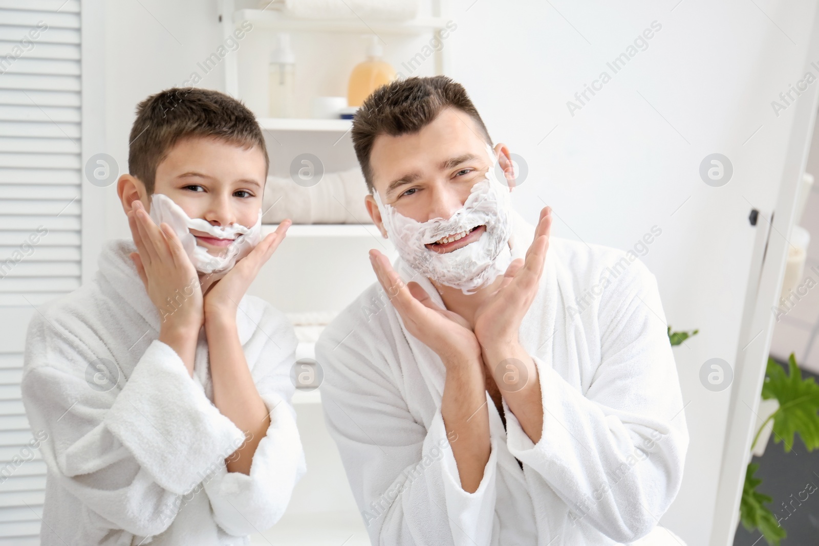 Photo of Dad teaching his son to shave in bathroom