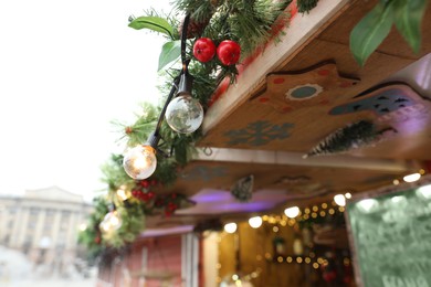 Christmas fair stall with string lights outdoors, closeup