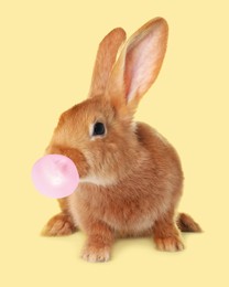 Cute bunny with bubble of chewing gum on pale yellow background