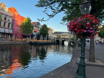 Leiden, Netherlands - August 1, 2022: Picturesque view of city canal and beautiful buildings