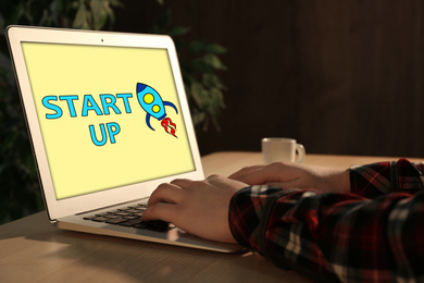 Woman using laptop at desk in office, closeup. Startup idea