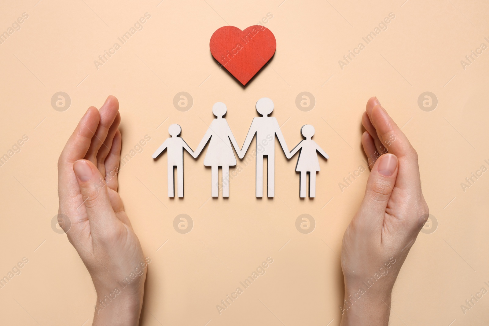 Photo of Woman protecting figures of family on beige background, top view. Insurance concept
