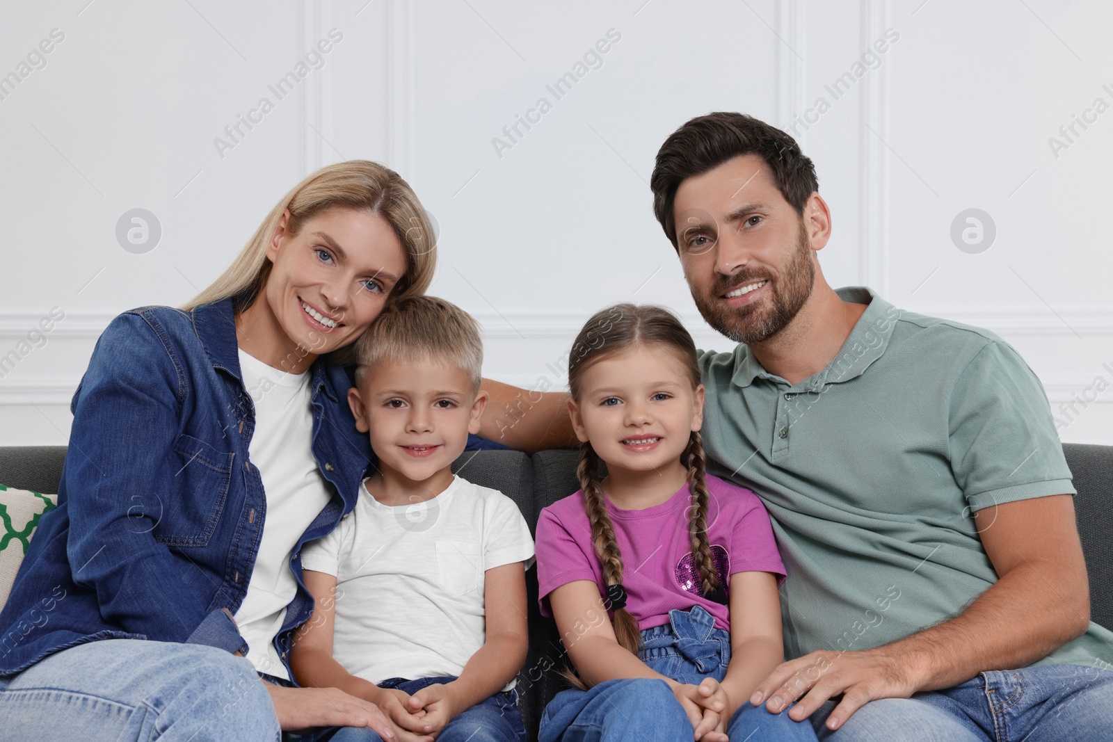 Photo of Portrait of happy family with children on sofa at home