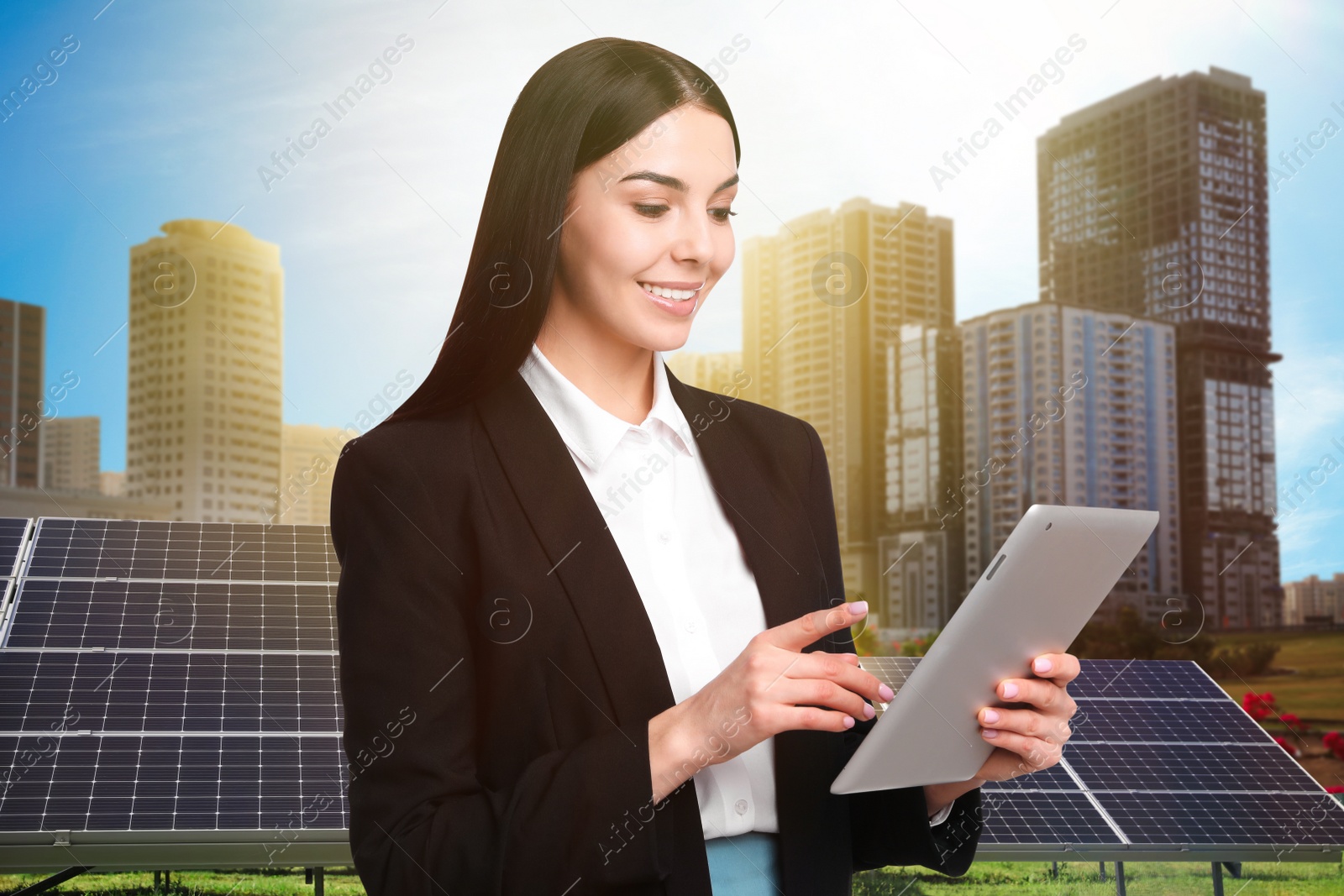 Image of Young businesswoman with tablet near solar panels and beautiful view of cityscape. Alternative energy source